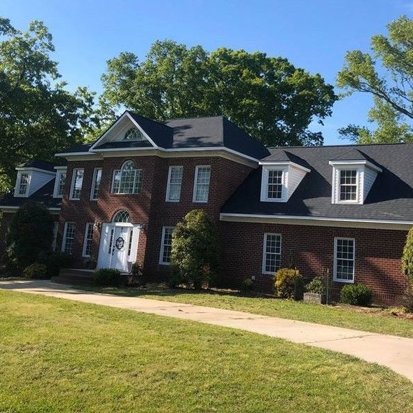 Brick colonial home with a new shingle roof