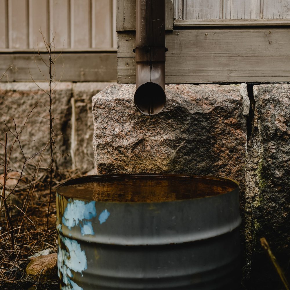 Close-up of a downspout draining away from a home