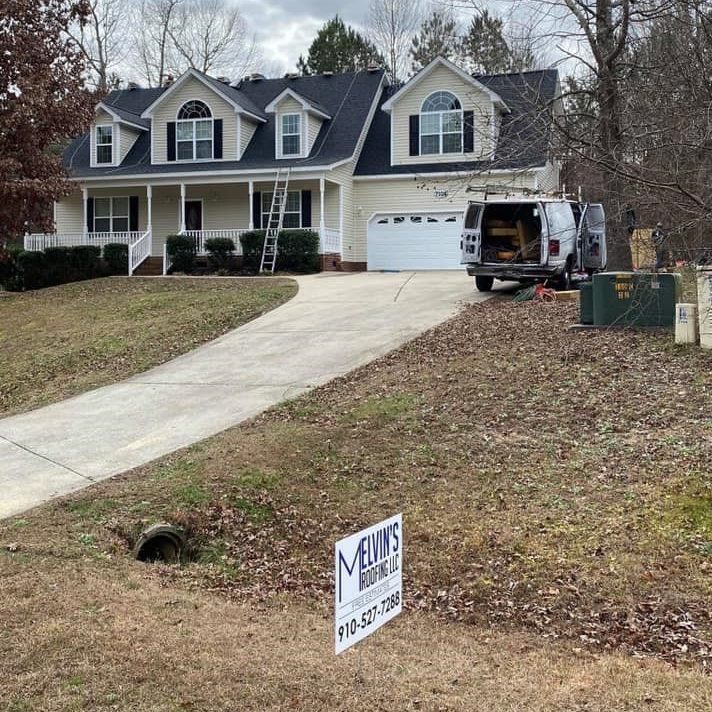 Roof replacement job site with a Melvin's Roofing yard sign